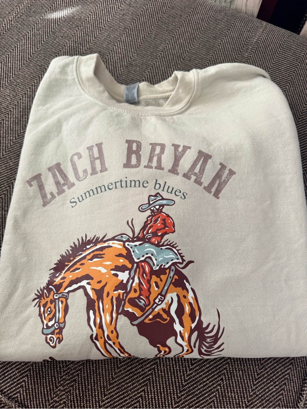 Zach Bryan Summertime Blues Cream Sweatshirt with Orange and Teal Rodeo Graphic